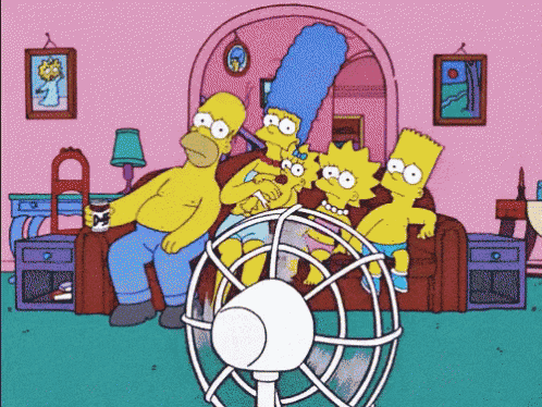 A family on the couch together without air conditioning, leaning back and forth following the fan to stay cool.