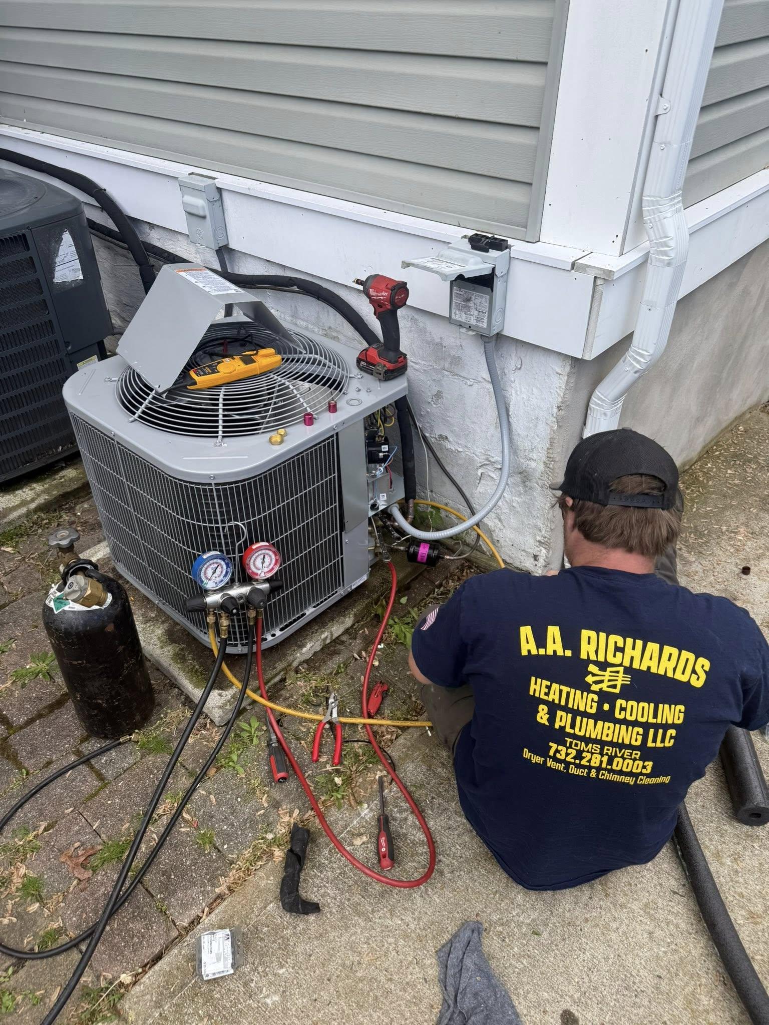 Technician servicing an air conditioning unit